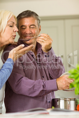 Mature couple preparing meal together