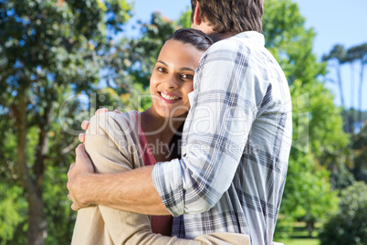 Happy couple hugging in park