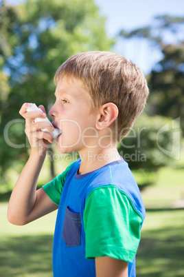 Little boy using his inhaler Little boy using his inhaler