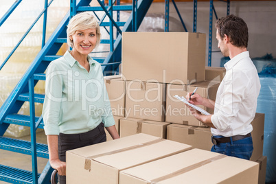 Focused warehouse managers with clipboard