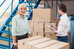 Focused warehouse managers with clipboard