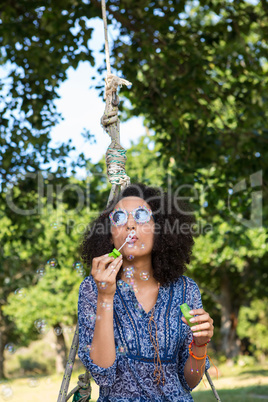 Pretty young woman in tire swing