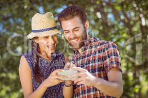 Hipster couple looking at phone