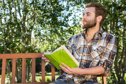 Handsome hipster relaxing in the park