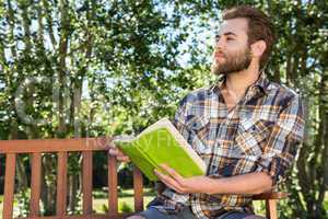 Handsome hipster relaxing in the park