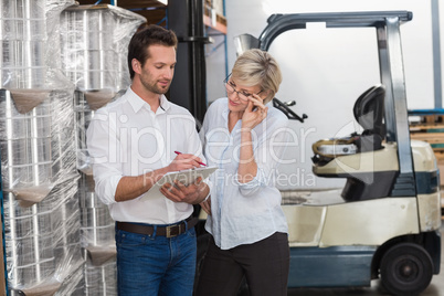 Warehouse team working together with clipboard