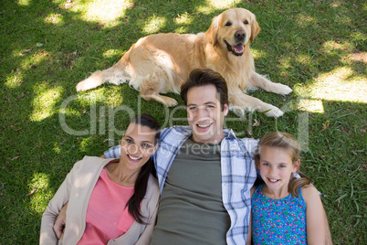 Happy family with their dog in the park