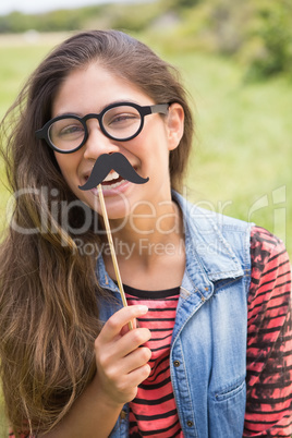 Pretty brunette with fake mustache