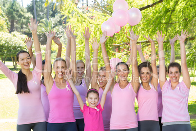 Smiling women in pink for breast cancer awareness