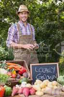 Farmer selling organic veg at market