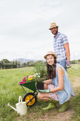 Happy young couple gardening together