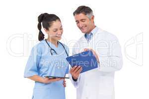 Doctor and nurse looking at clipboard