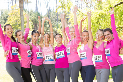 Smiling women running for breast cancer awareness