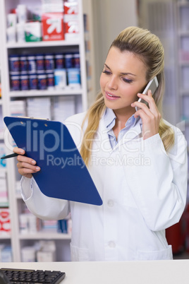 Young pharmacist on the phone Young pharmacist on the phone