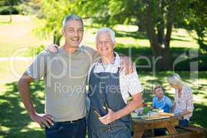 Happy man doing barbecue with his father