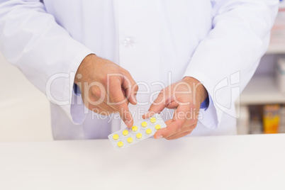 Pharmacist holding blister packs