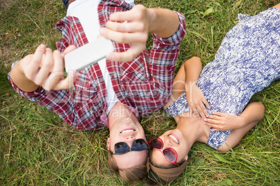 Couple relaxing in the park taking selfie