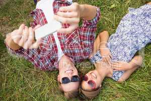 Couple relaxing in the park taking selfie