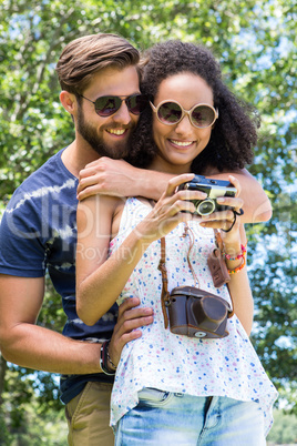 Hipster couple looking at their camera