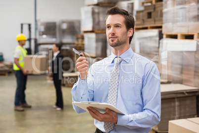 Warehouse manager checking his inventory