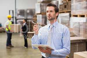 Warehouse manager checking his inventory