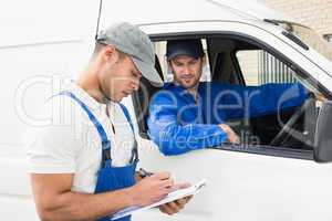 Delivery man getting signature from customer