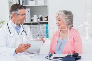 Doctor explaining prescriptions to senior patient