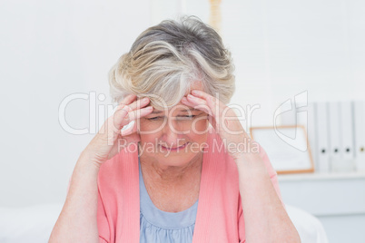Tensed senior patient suffering from headache