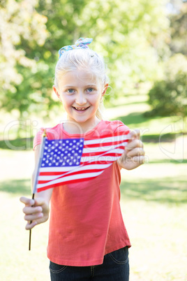 Little girl waving american flag