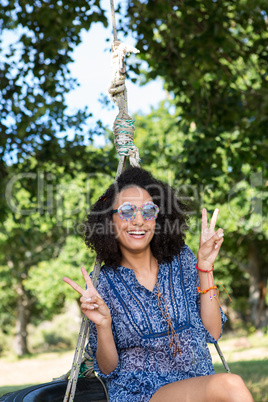 Pretty young woman in tire swing