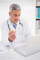 Doctor typing on keyboard the prescriptions