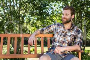 Handsome hipster relaxing in the park