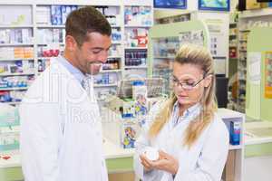 Team of pharmacists looking at medicine