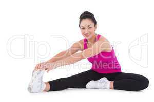 Fit woman stretching her legs