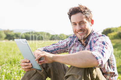 Young man using tablet in the countryside