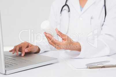 Doctor typing on keyboard the prescriptions