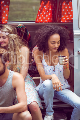 Hipster friends in camper van at festival