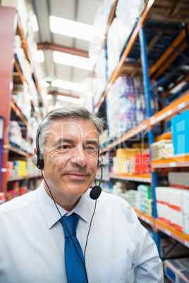 Warehouse manager giving orders on headset
