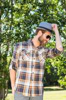 Handsome hipster smiling in the park