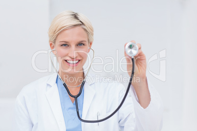 Confident female doctor holding stethoscope