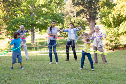 Extended family playing with hula hoops