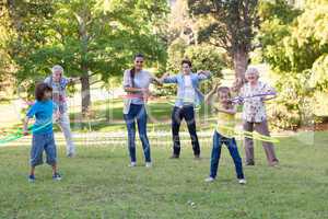 Extended family playing with hula hoops