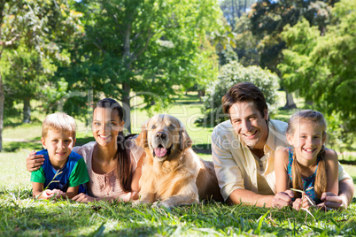 Happy family with their dog in the park