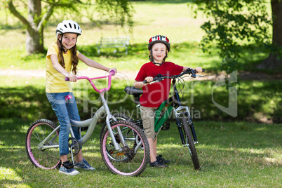 Happy siblings on their bike