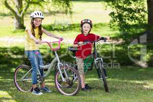 Happy siblings on their bike
