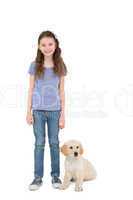 Smiling little girl standing next to dog