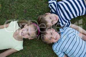 Happy siblings smiling at camera together