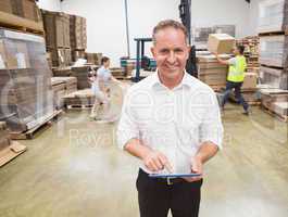 Manager using digital tablet during busy period