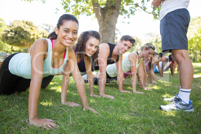 Fitness group planking in park