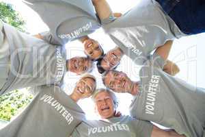 Happy volunteer family looking down at the camera